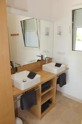 a bathroom with two sinks and a mirror at Le Fournil en Provence in Caseneuve