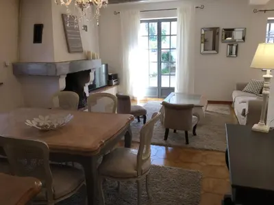 a living room with a table and chairs at authentic provencal mas with pool, in the countryside of the village of sénas, close to the luberon and the alpilles, sleeps 8. in Sénas