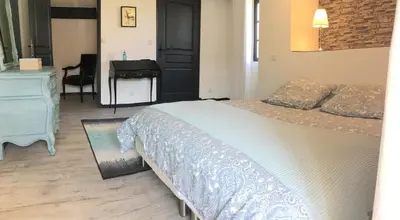 a bedroom with a bed and a dresser and a desk at authentic provencal mas with pool, in the countryside of the village of sénas, close to the luberon and the alpilles, sleeps 8. in Sénas