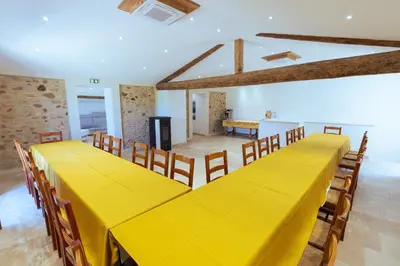 a large yellow table and chairs in a room at Chambres & Tables d'hôtes Moulin de Lavon in Gargas