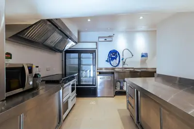 a large kitchen with stainless steel appliances at Chambres & Tables d'hôtes Moulin de Lavon in Gargas