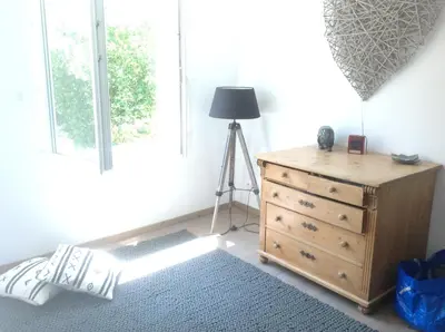 a room with a dresser and a lamp next to a window at Petite Maison du Ventoux in Mormoiron