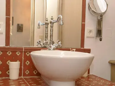 a white sink in a bathroom with a mirror at Splendid Villa in Viens with Swimming Pool in Viens