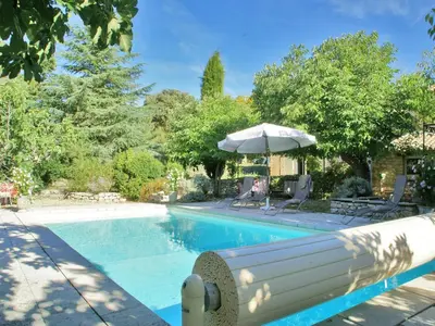 a swimming pool with an umbrella and chairs and a table at Splendid Villa in Viens with Swimming Pool in Viens