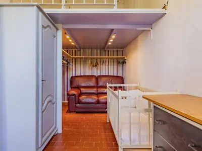 a living room with a leather chair in a room at Holiday Home Bastide du 19ième by Interhome in Oppède