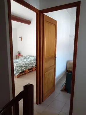 a door leading to a bedroom with a bed at Gîte des deux platanes in Orgon