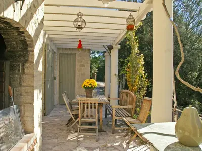 a patio with a table and chairs under a pergola at Villa in Crillon-le-Brave near Mont Ventoux in Crillon-le-Brave