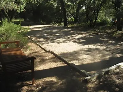 a bench sitting next to a path with trees at Villa in Crillon-le-Brave near Mont Ventoux in Crillon-le-Brave