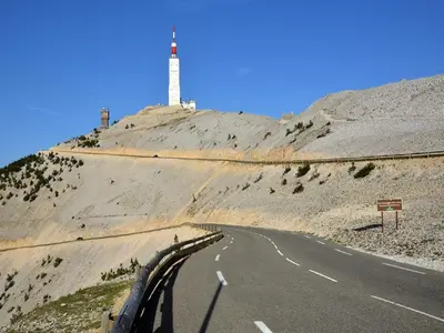 a road with a lighthouse on the side of a hill at Villa in Crillon-le-Brave near Mont Ventoux in Crillon-le-Brave
