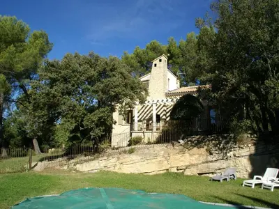 a house with two lawn chairs in front of it at Villa in Crillon-le-Brave near Mont Ventoux in Crillon-le-Brave