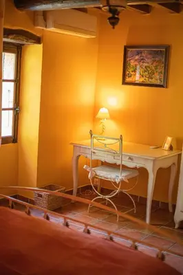 a room with a white desk and a chair at Le Vieux Moulin de Jouques in Jouques