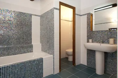 a bathroom with a tub and a sink and a toilet at La Maison du Peintre en Provence in Mallemort