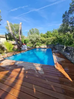 a swimming pool on a wooden deck at Le Mas des Anges in Cheval-Blanc