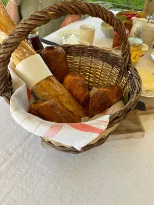 a basket filled with bread on top of a table at Le Domaine Saint Jean in Saint-Saturnin-les-Apt