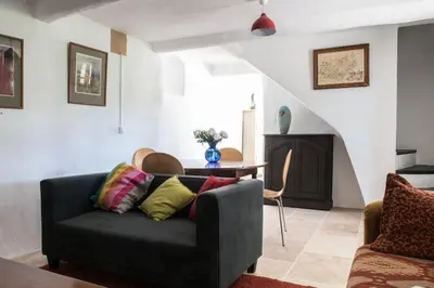 a living room with a couch and a fireplace at Le Domaine Saint Jean in Saint-Saturnin-les-Apt