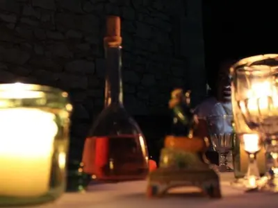 a bottle of wine sitting on a table with candles at Le Domaine Saint Jean in Saint-Saturnin-les-Apt