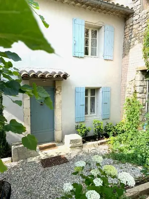 a house with blue shuttered windows and a blue door at Le Domaine Saint Jean in Saint-Saturnin-les-Apt