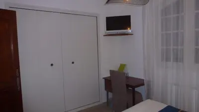 a room with a white closet with a tv on the wall at Chambre d'hôtes La Pinede in Lambesc