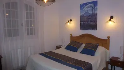 a bedroom with a bed with two pillows on it at Chambre d'hôtes La Pinede in Lambesc