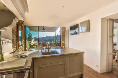 a kitchen with a sink and a large window at Villa Sunset in Gordes in Gordes