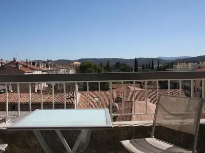 a white table and a chair on a balcony at Le Concorde in Aix-en-Provence