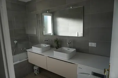 a bathroom with two sinks and a mirror at Golf de Pont Royal Villa du Lac climatisée 3 chambres Piscine chauffée Parking et Garage in Mallemort