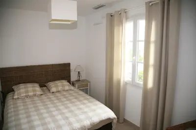 a bedroom with a bed and a window at Golf de Pont Royal Villa les Micocouliers climatisée 4 chambres Piscine chauffée Parking in Mallemort