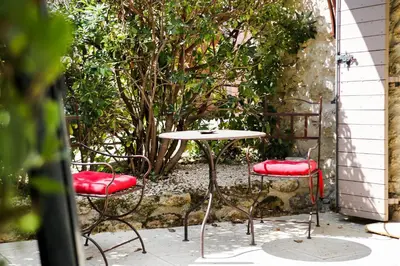 a table and two chairs and a table and a table and chairs at Le Mas de la Lombarde in Lourmarin