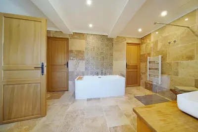a large bathroom with a tub and a shower at Mas des Baussiers in Saint-Martin-de-Castillon