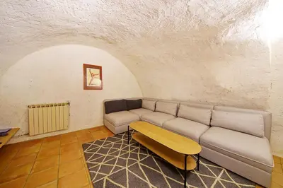 a living room with a couch and a table at Mas des Baussiers in Saint-Martin-de-Castillon