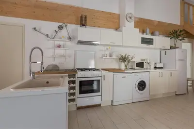 a kitchen with white appliances and a sink at Lou Cardalines in Bédoin