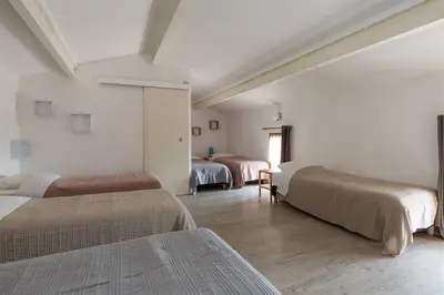 a room with three beds in a room at Lou Cardalines in Bédoin