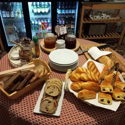 a table with different types of bread and pastries at La Garance in Bédoin