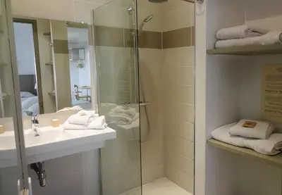 a bathroom with a shower and a sink at La Garance in Bédoin
