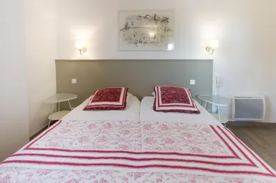 a bedroom with a bed with two pillows on it at La Garance in Bédoin