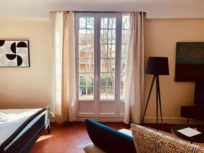 a room with a bed and a large window at B&B Villa Roumanille in Aix-en-Provence