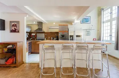 a kitchen with a island with bar stools at Duplex 6 personnes, ascenseur, zone pietonne, 1 bis Rue Aude in Aix-en-Provence
