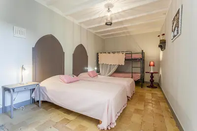a bedroom with two beds with pink pillows at Bastide de Fanny in Rognes