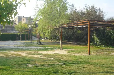 a park with a wooden pavilion in the grass at Lou mas li Pitchoun 