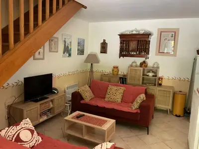 a living room with a couch and a tv at Les Cigales in Saint-Andiol