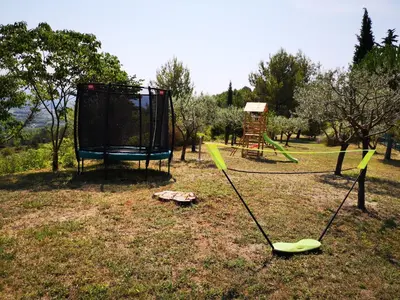 a park with a swing set and a playground at La Bastide du Limon in Mormoiron