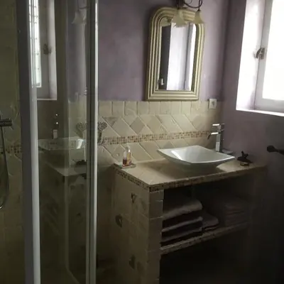 a bathroom with a sink and a glass shower at OUSTAU DE PIERA in Gordes