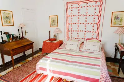 a bedroom with a bed and a dresser and a desk at Le Domaine de Saint Veran in Orgon