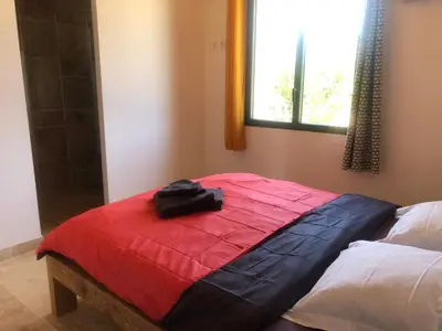 a bag sitting on top of a bed in a room at Mas Eléhis Gîtes en Provence in Pernes-les-Fontaines