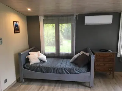 a small bed in a room with a window at La Gourmandine in Saint-Andiol
