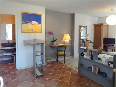 a living room with a table and a desk at Gite La Gourmandine in Saint-Andiol