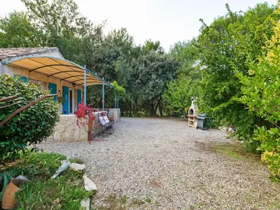 a large gravel yard next to a house at Modern holiday home with private pool in Lambesc