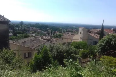 a view of a town from a hill at La petite maison avec piscine face au Luberon in Robion en Luberon