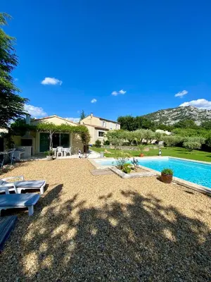 a villa with a swimming pool and a house at La petite maison avec piscine face au Luberon in Robion en Luberon