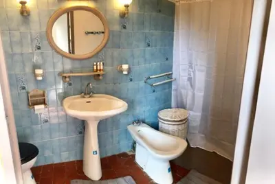 a bathroom with a sink and a toilet and a mirror at Fontaine-de-Vaucluse : maison avec vues in Fontaine-de-Vaucluse